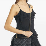 Black bag carried by a person, showing the bag’s fit