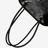 Close up of black bags, showing texture of the calf leather fabric.