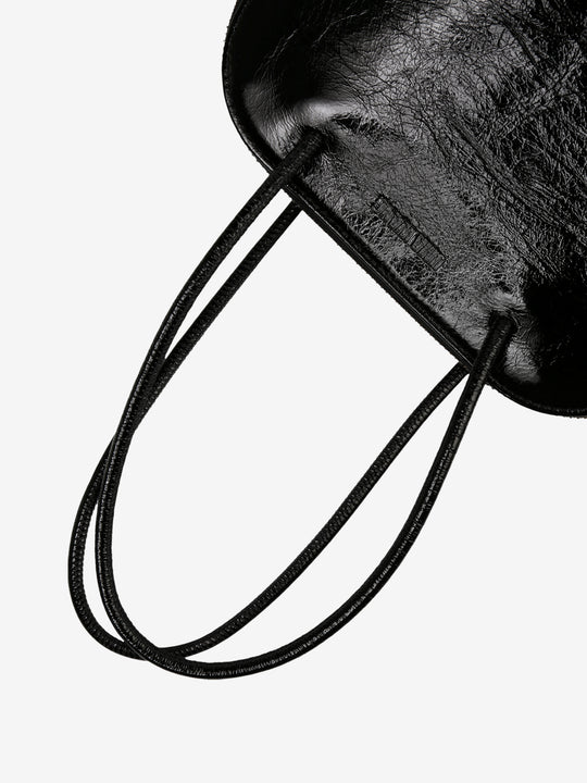 Close up of black bags, showing texture of the calf leather fabric.