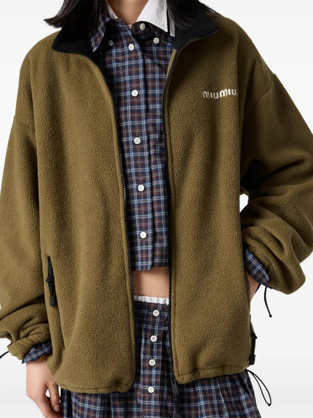Green jacket worn by a person, showing the jacket fit