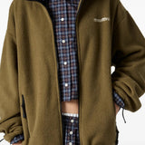 Green jacket worn by a person, showing the jacket fit