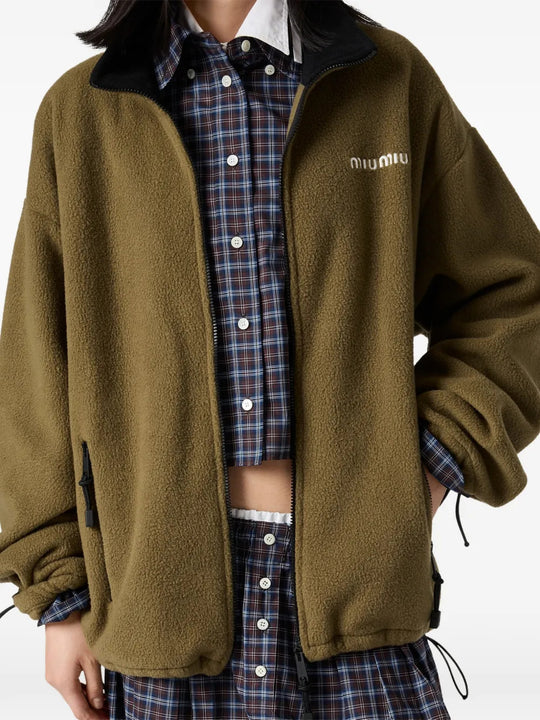 Green jacket worn by a person, showing the jacket fit
