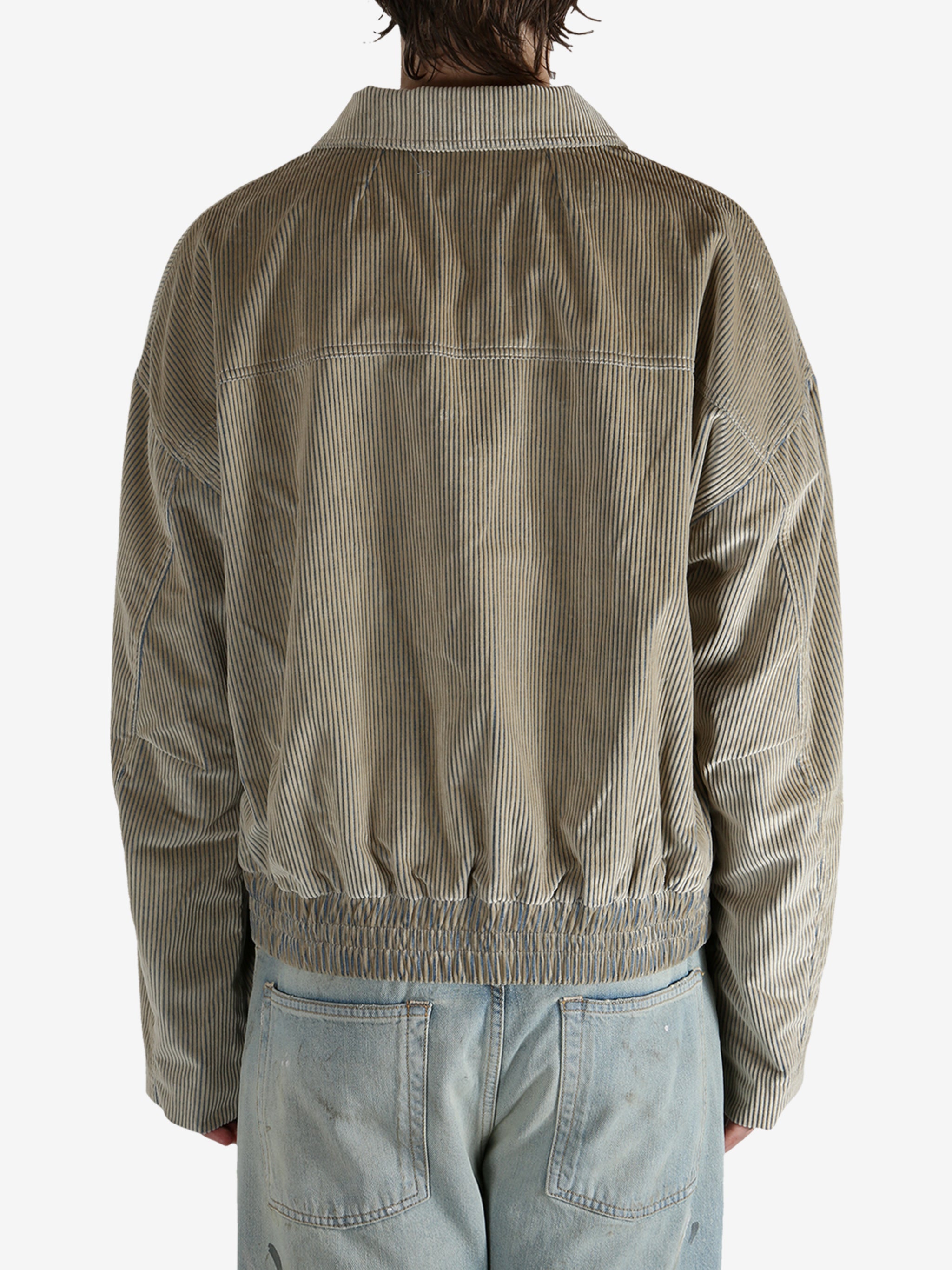 Tan jacket worn by a person, showing the jacket’s fit
