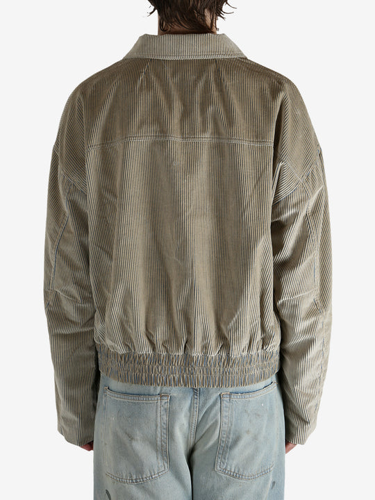 Tan jacket worn by a person, showing the jacket’s fit