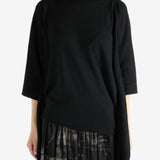 Black top worn by a person, showing the top's fit