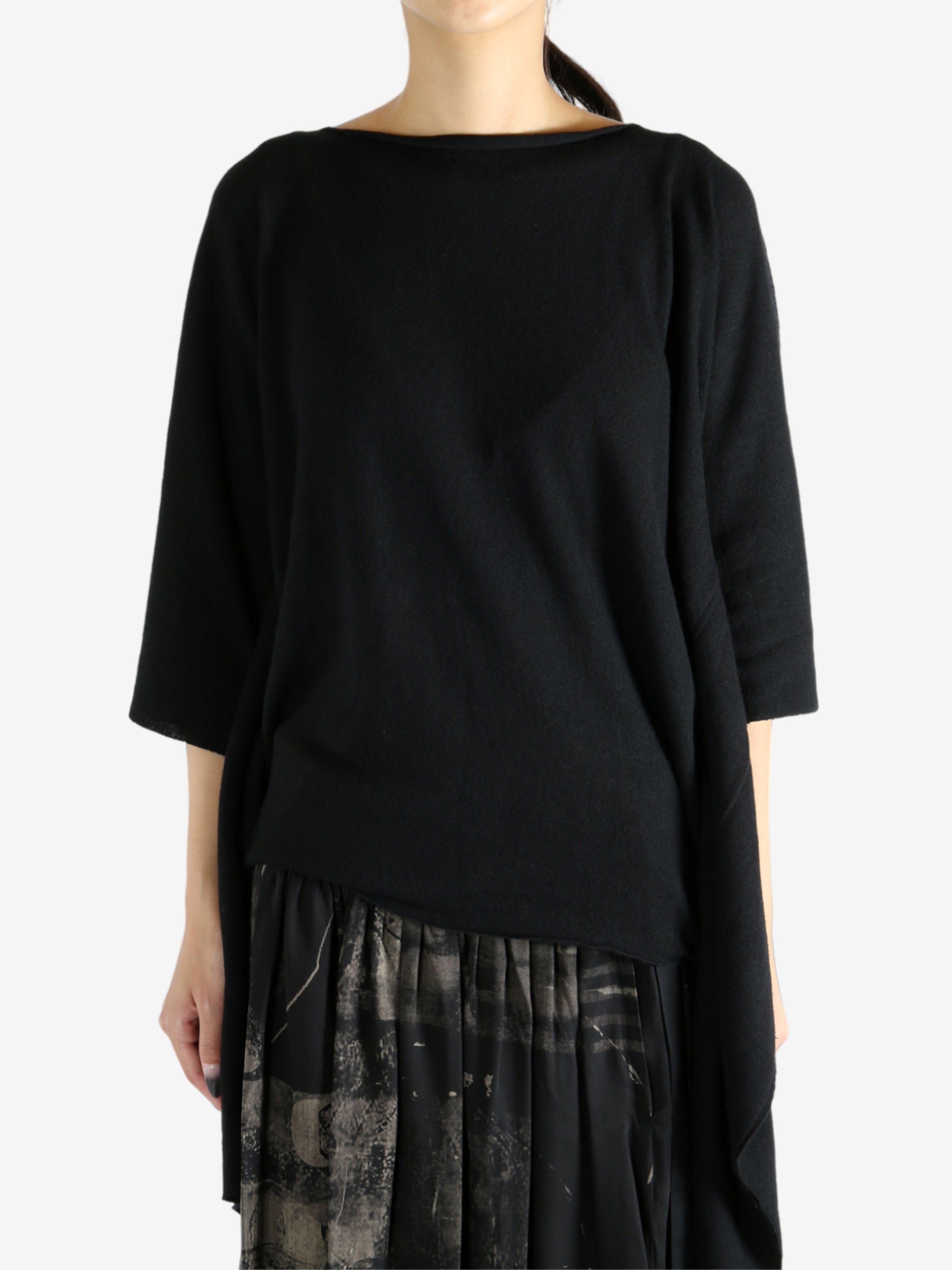 Black top worn by a person, showing the top's fit