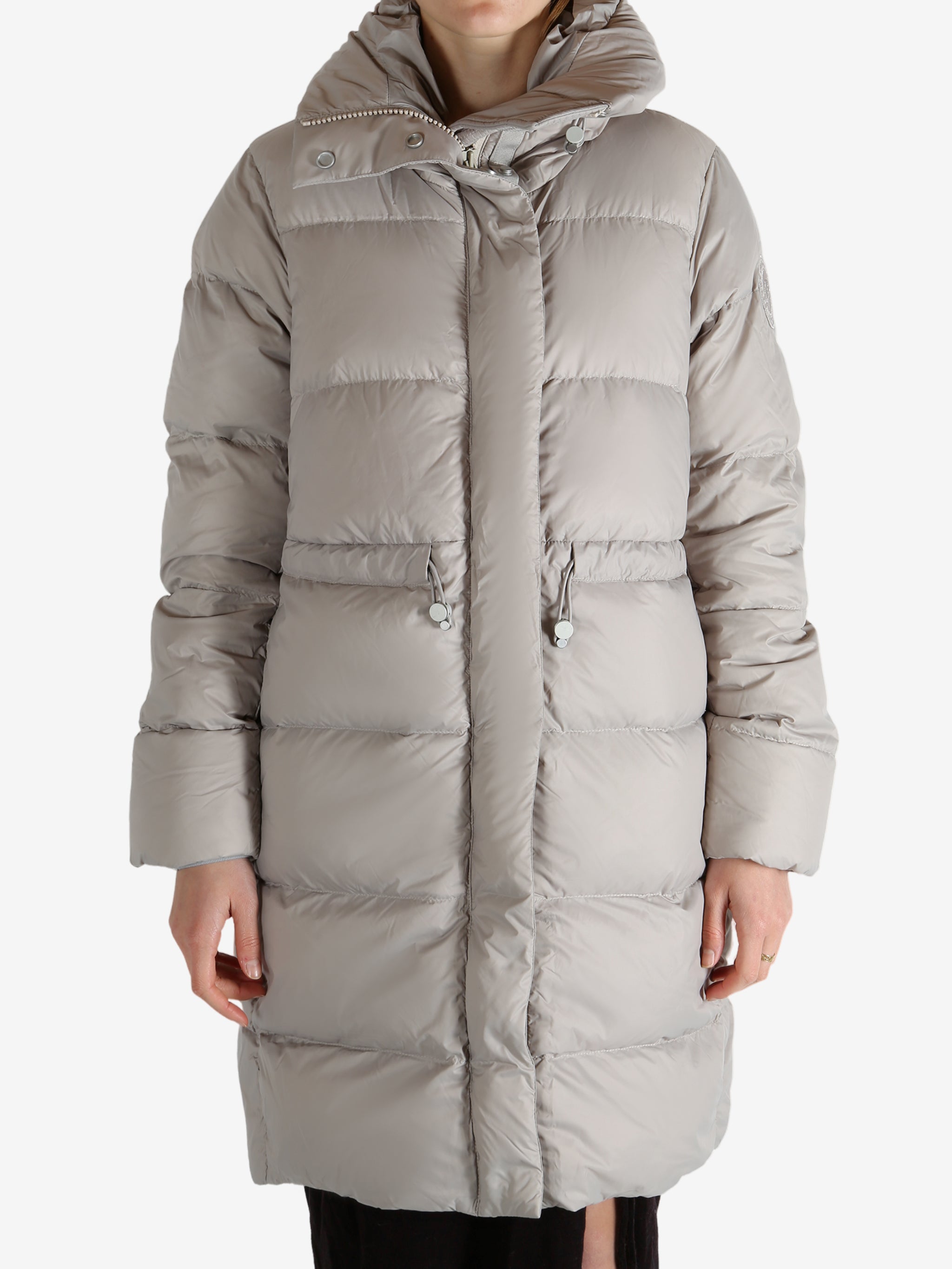 Grey coat worn by a person, showing the coat fit