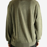 Green sweater worn by a person, showing the sweater's fit