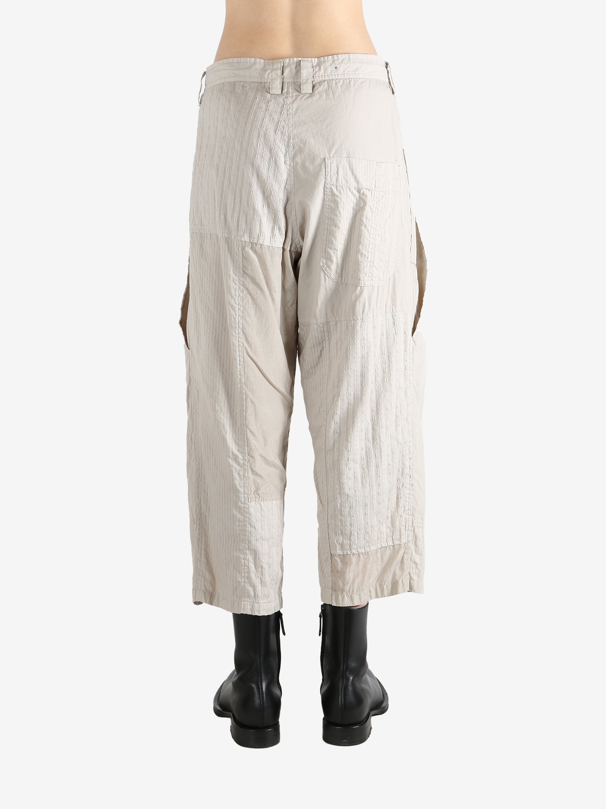 White pants worn by a person, showing the pants fit