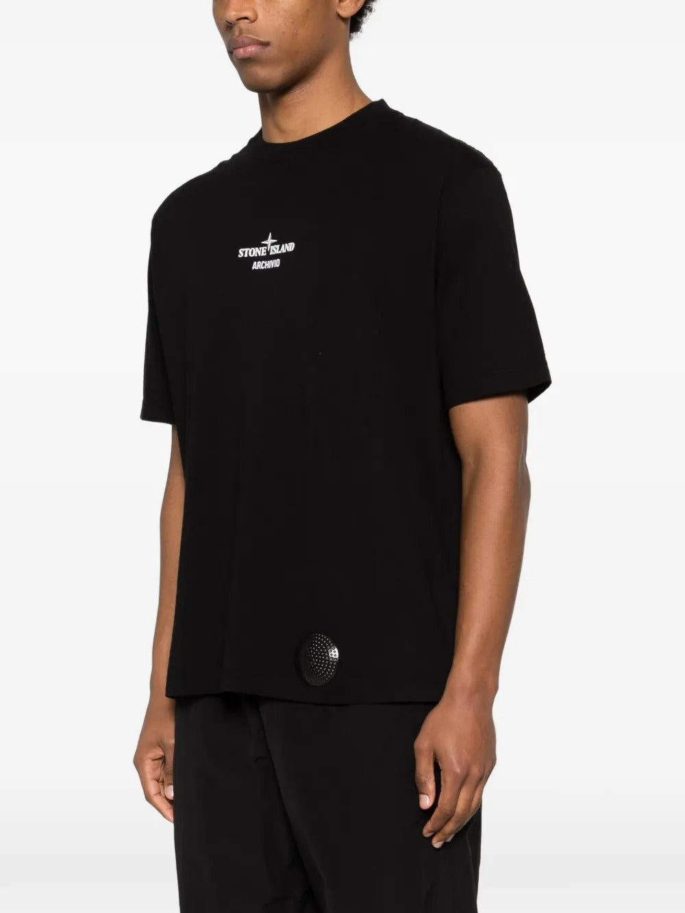 Black t-shirts worn by a person, showing the t-shirts fit