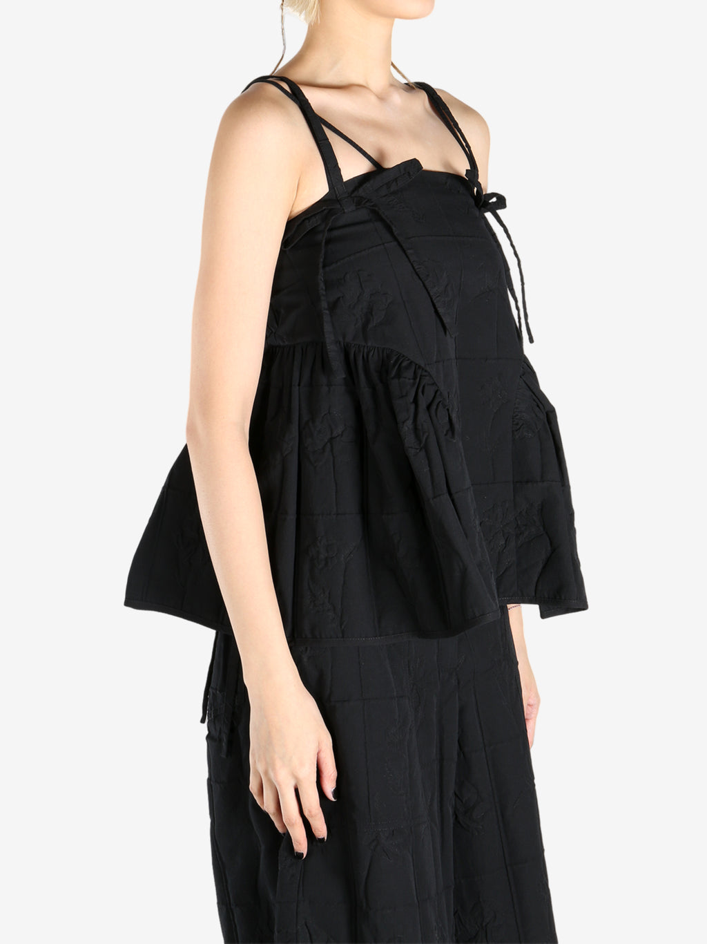 Black top worn by a person, showing the top fit