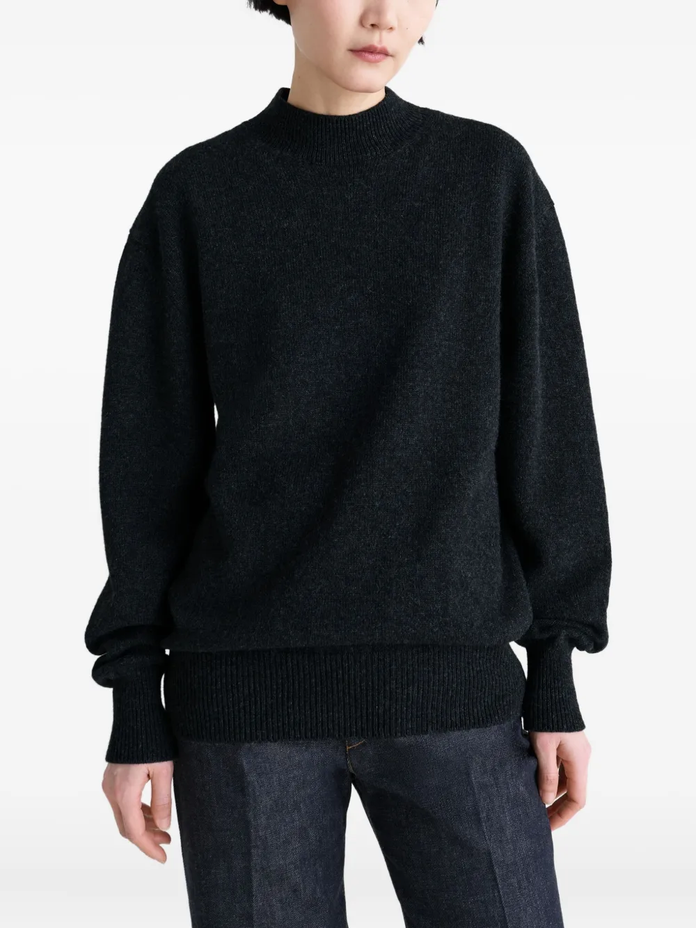 Black knitwear worn by a person, showing the knitwear fit