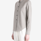 Grey shirt worn by a person, showing the shirt fit