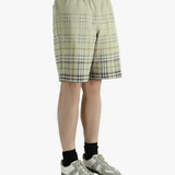 Green shorts worn by a person, showing the shorts fit