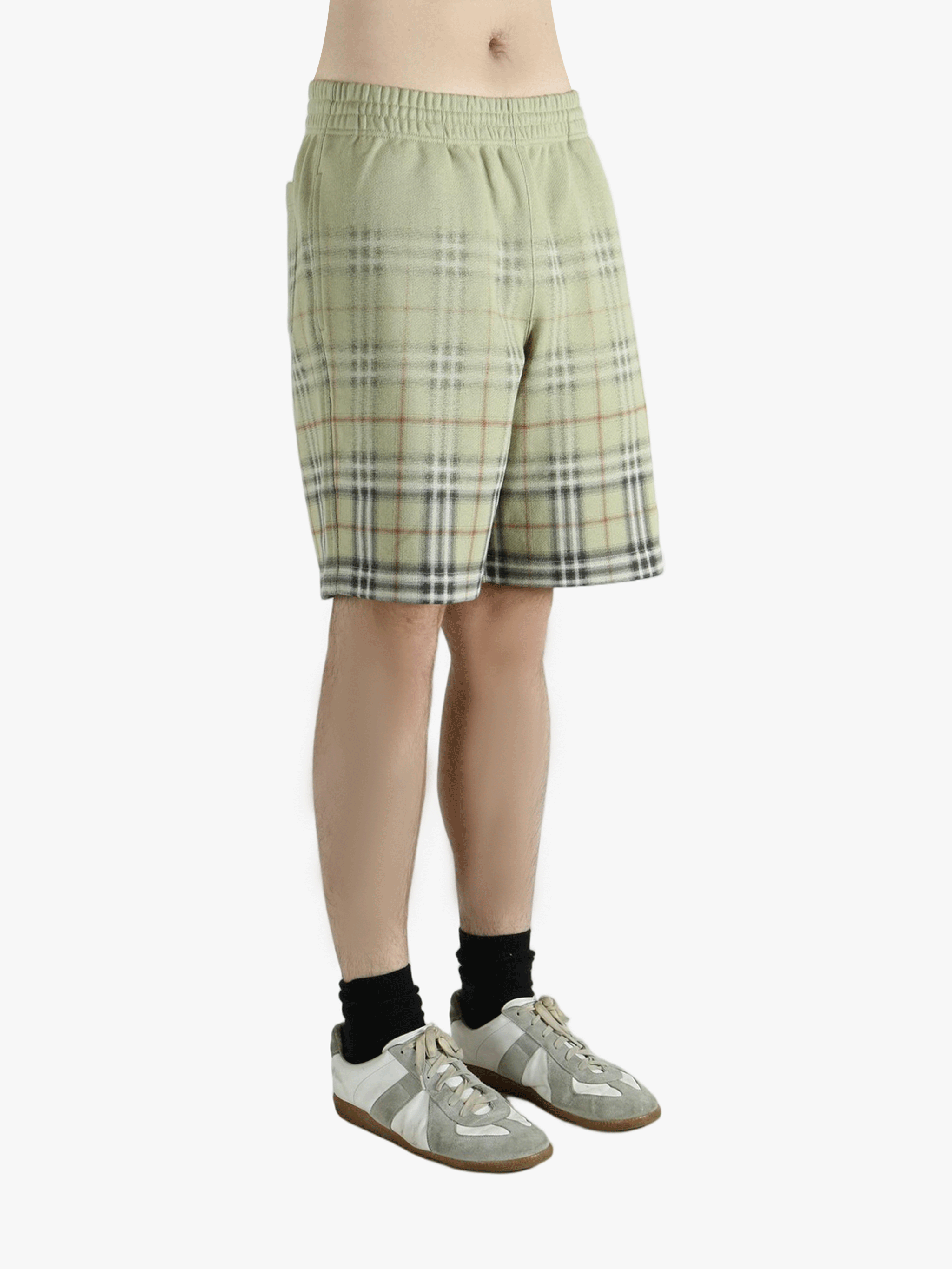 Green shorts worn by a person, showing the shorts fit