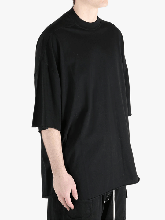 Black t-shirts worn by a person, showing the t-shirts fit