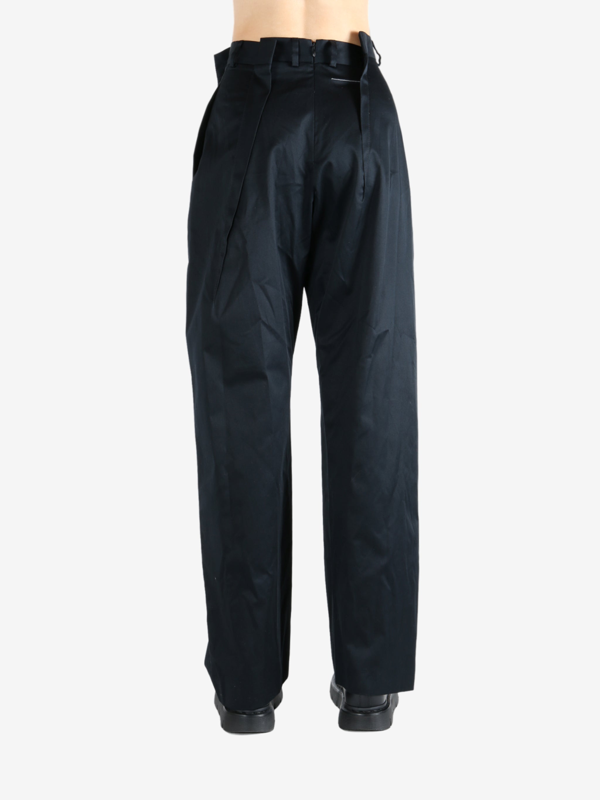 Black pants worn by a person, showing the pants fit