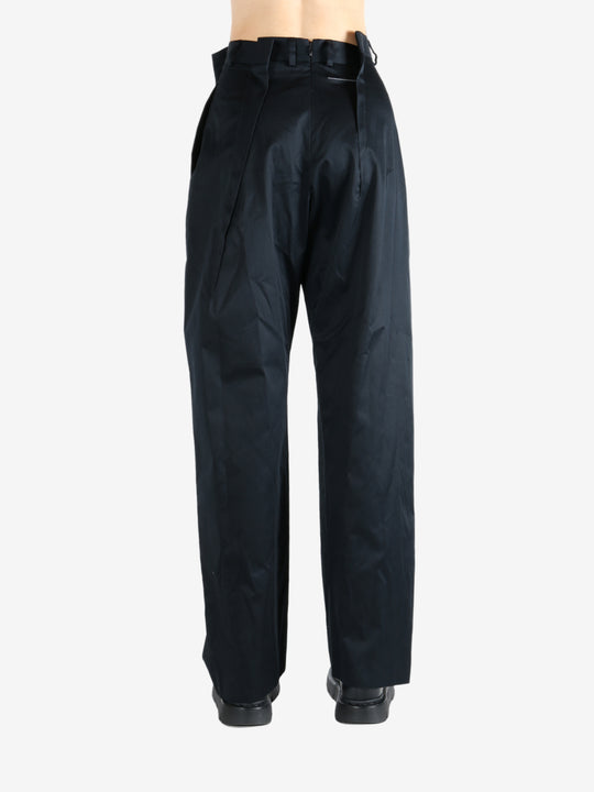 Black pants worn by a person, showing the pants fit