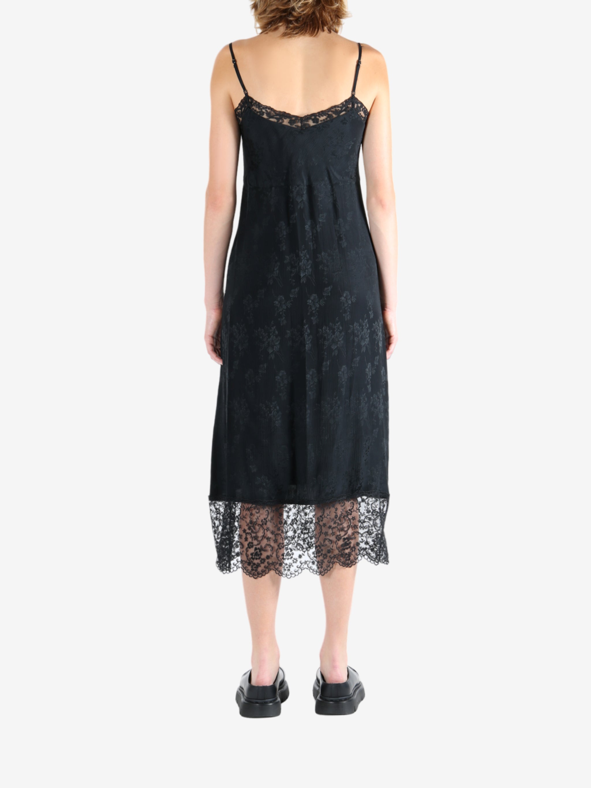 Black dress worn by a person, showing the dress's fit