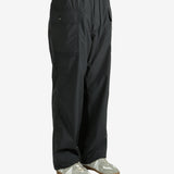 Black pants worn by a person, showing the pants's fit