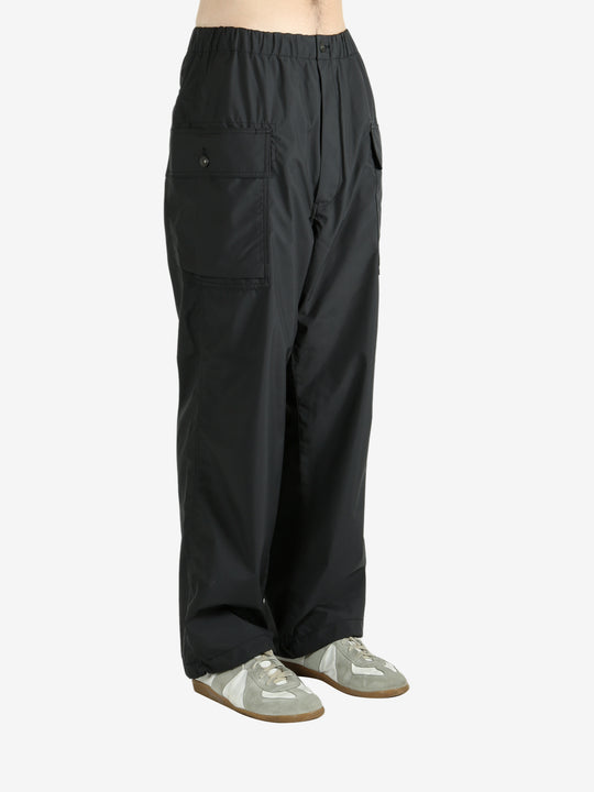 Black pants worn by a person, showing the pants's fit