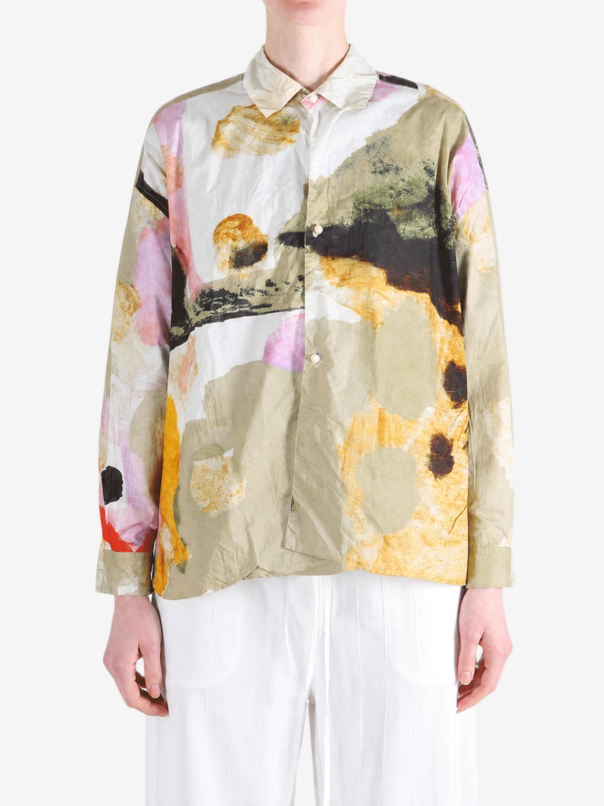 Tan shirt worn by a person, showing the shirt fit