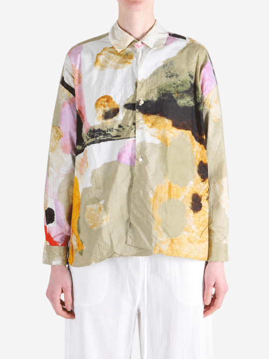 Tan shirt worn by a person, showing the shirt fit