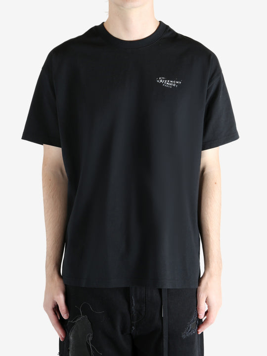 Black t-shirt worn by a person, showing the shirt's fit