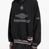black hoodie worn by a person, showing the  hoodie fit