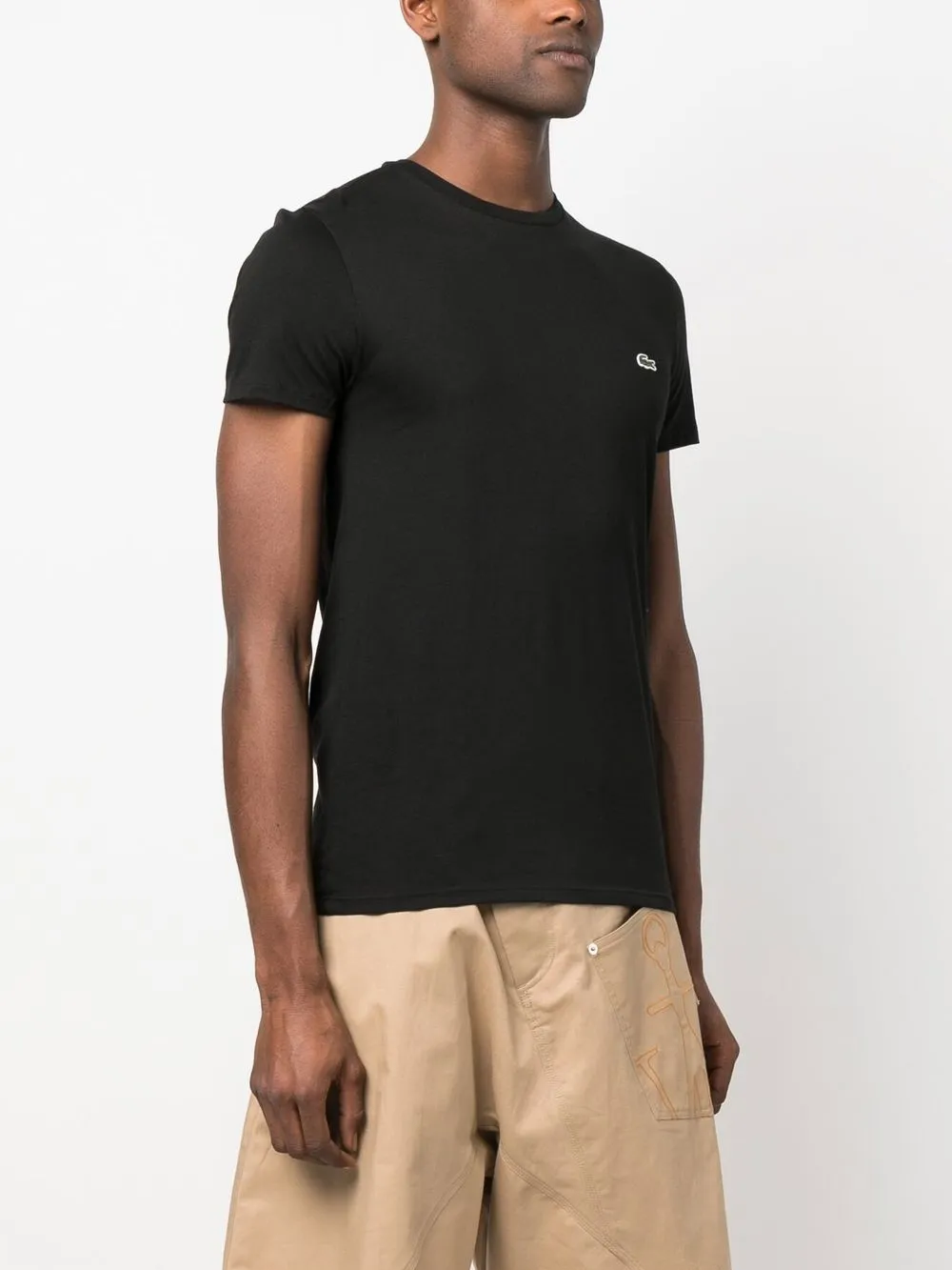 Black t-shirt worn by a person, showing the t-shirt's fit