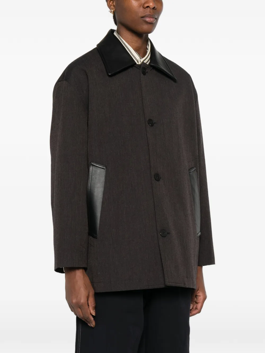 brown jackets-coats worn by a person, showing the  jackets-coats fit