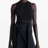 Black top worn by a person, showing the tops fit