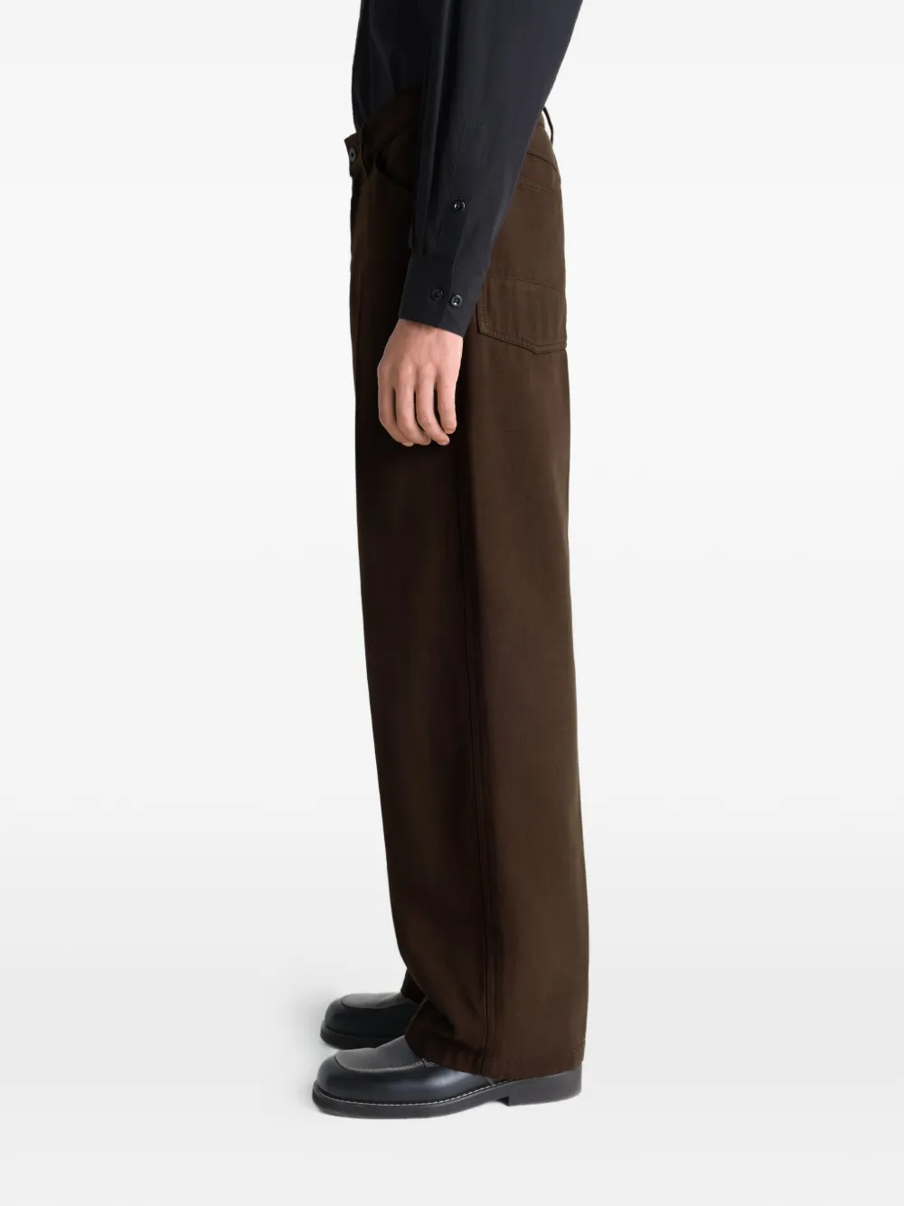 Brown pant worn by a person, showing the pant's fit