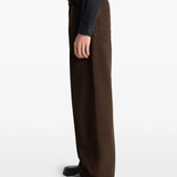 Brown pant worn by a person, showing the pant's fit