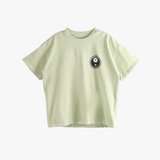 Green t-shirt worn by a person, showing the t-shirt's fit