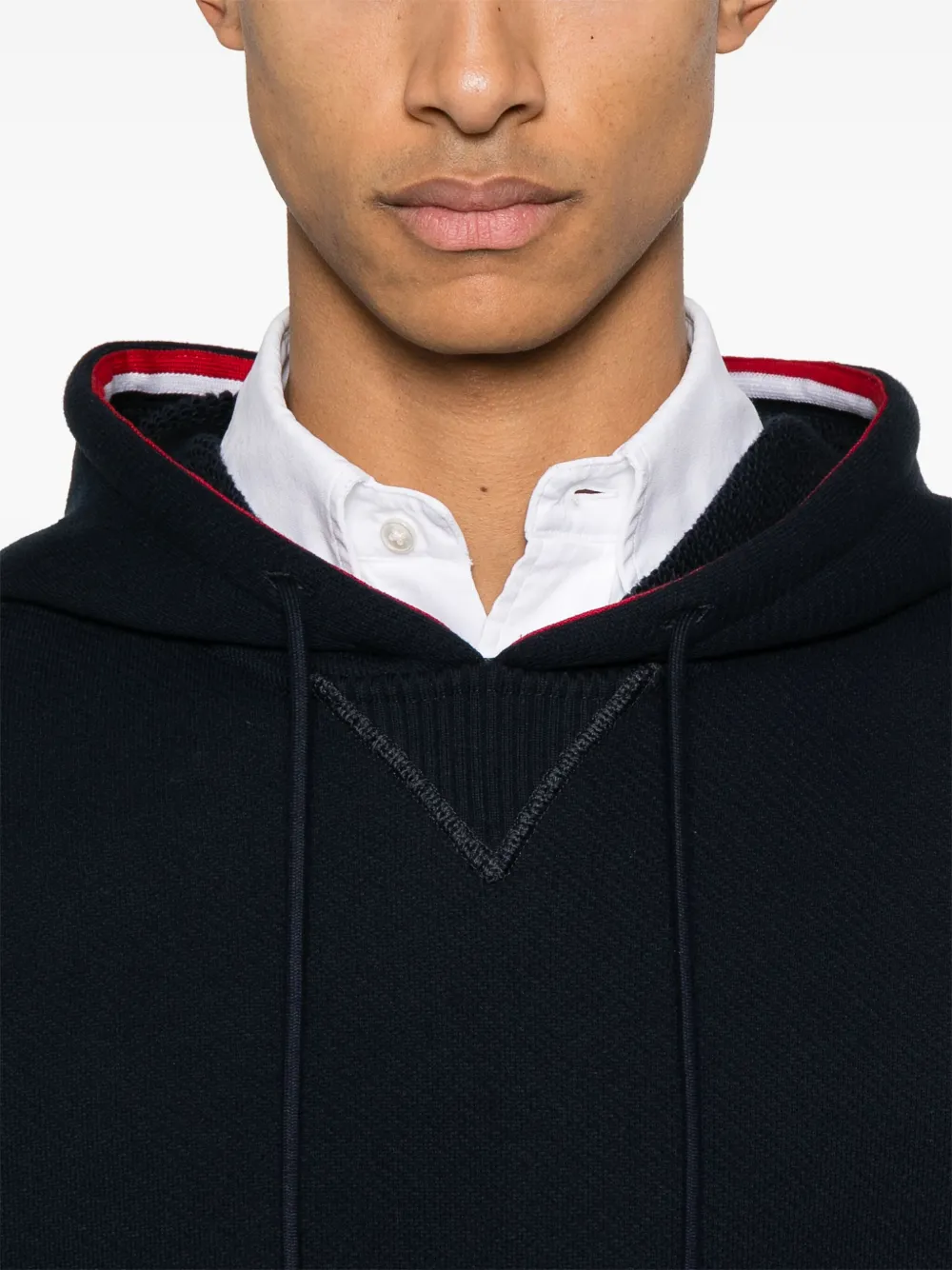 Close up of navy hoodies, showing texture of the cotton fabric