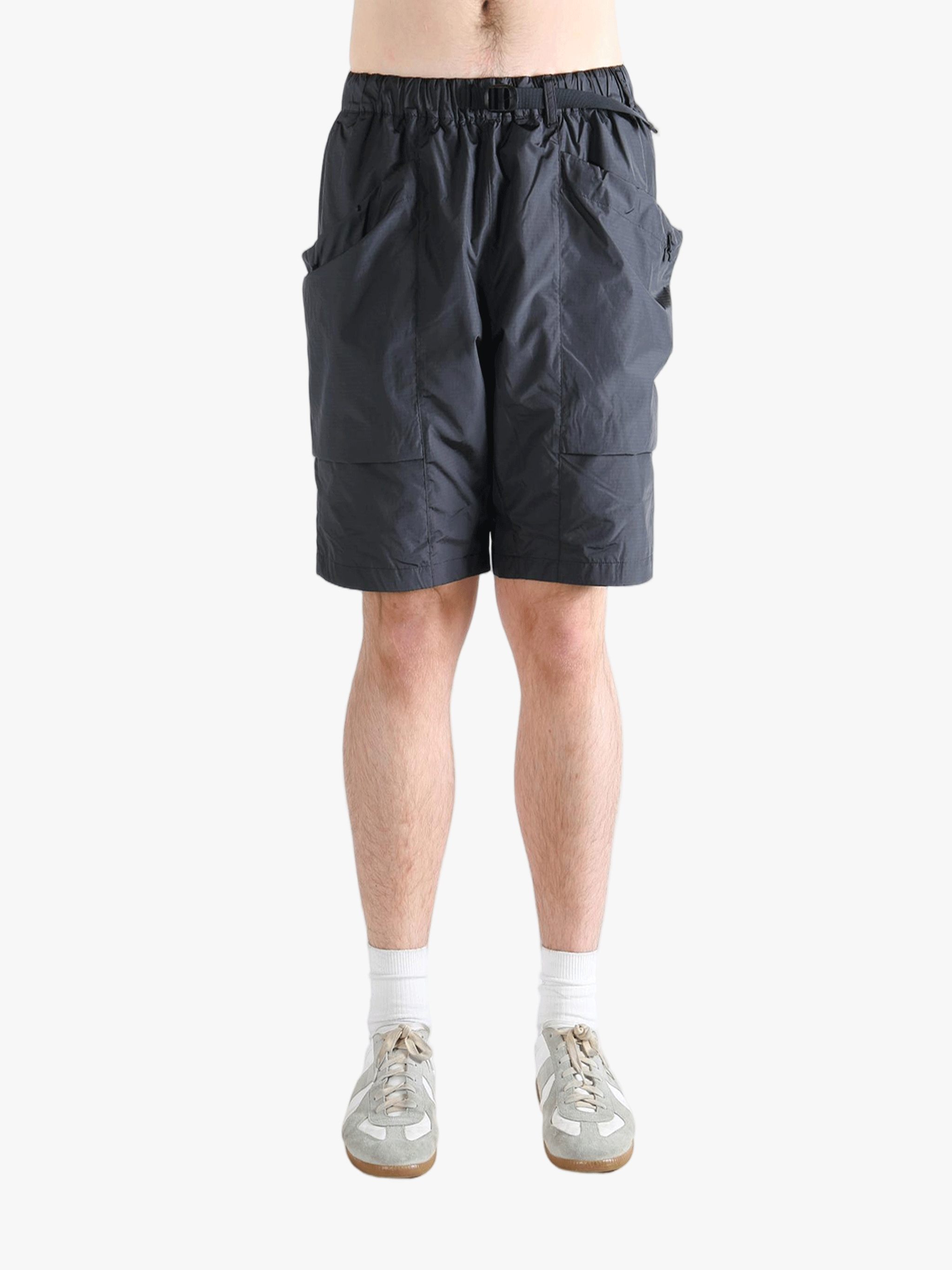 Gray shorts worn by a person, showing the short fit