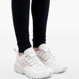 White snaekers worn by a person, showing sneakers' fit