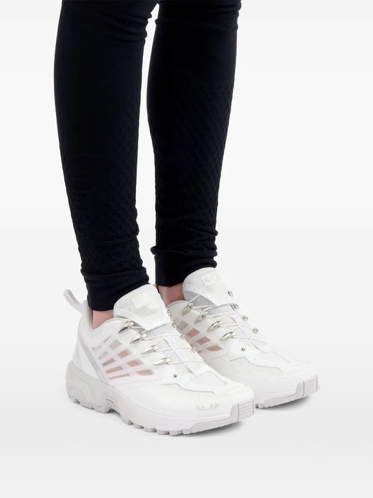 White snaekers worn by a person, showing sneakers' fit