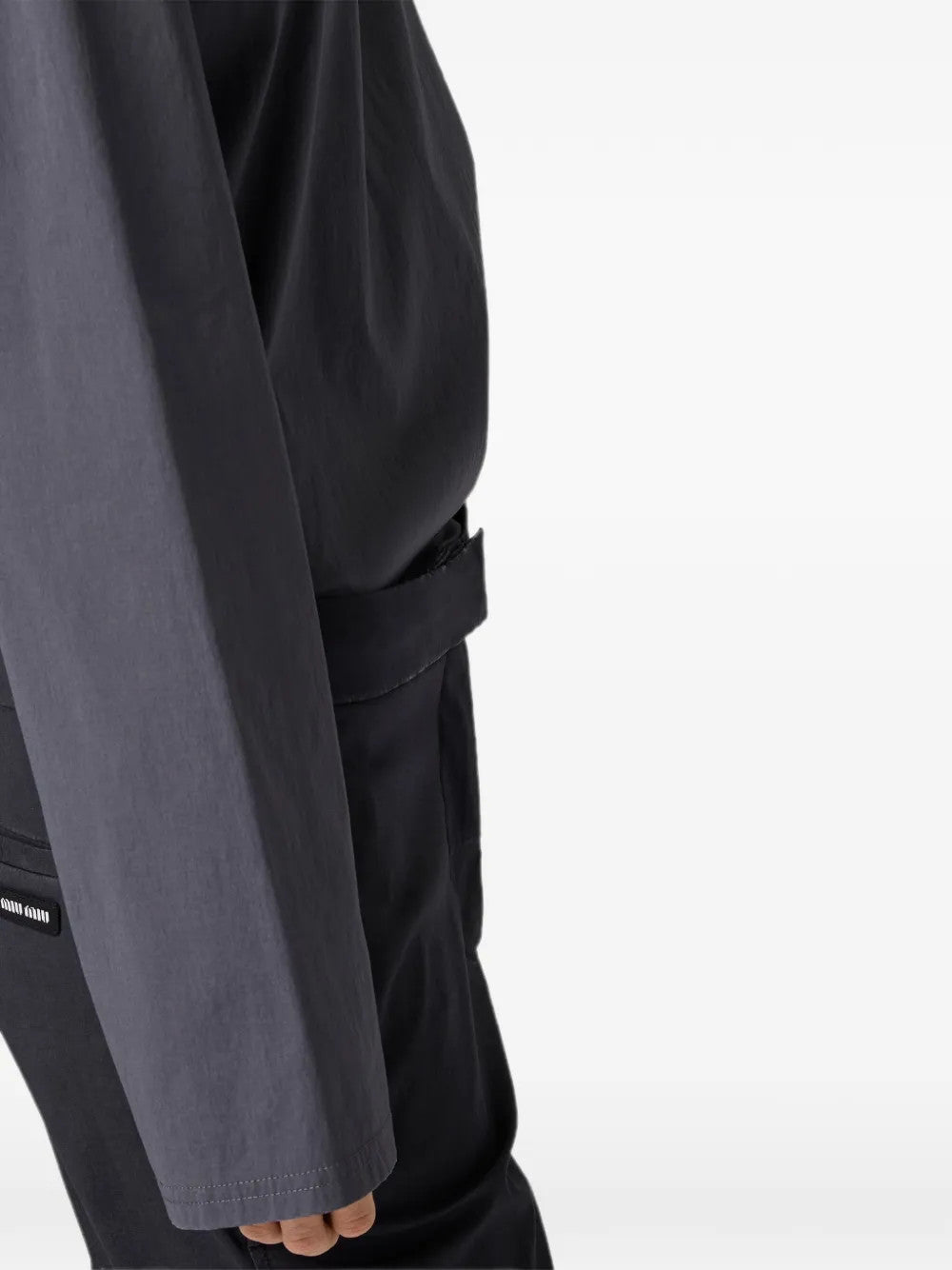 Grey top worn by a person, showing the top fit