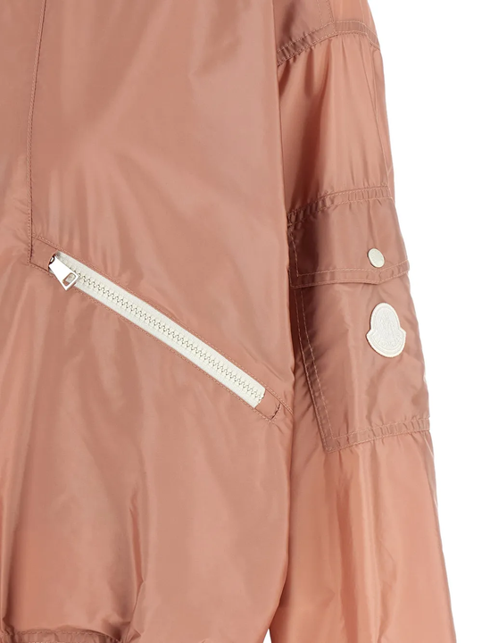 Close up of Pink jacket, showing the white logo-patch on shoulder