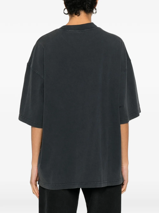 black t-shirts worn by a person, showing the t-shirts fit