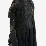 Black top worn by a person, showing the top's fit