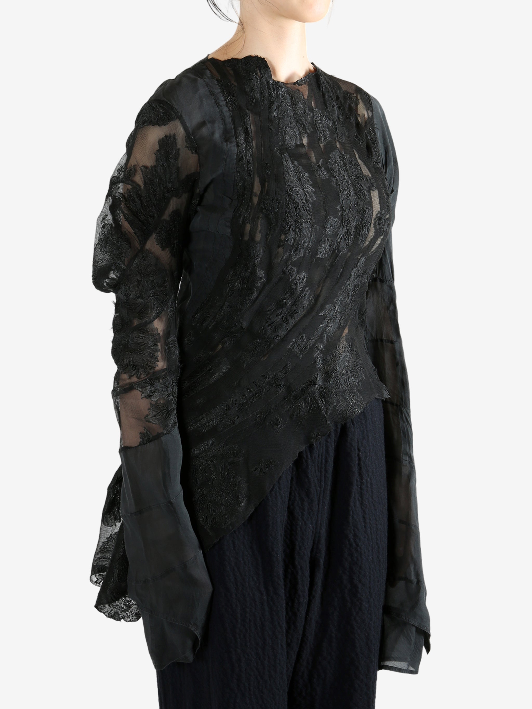 Black top worn by a person, showing the top's fit