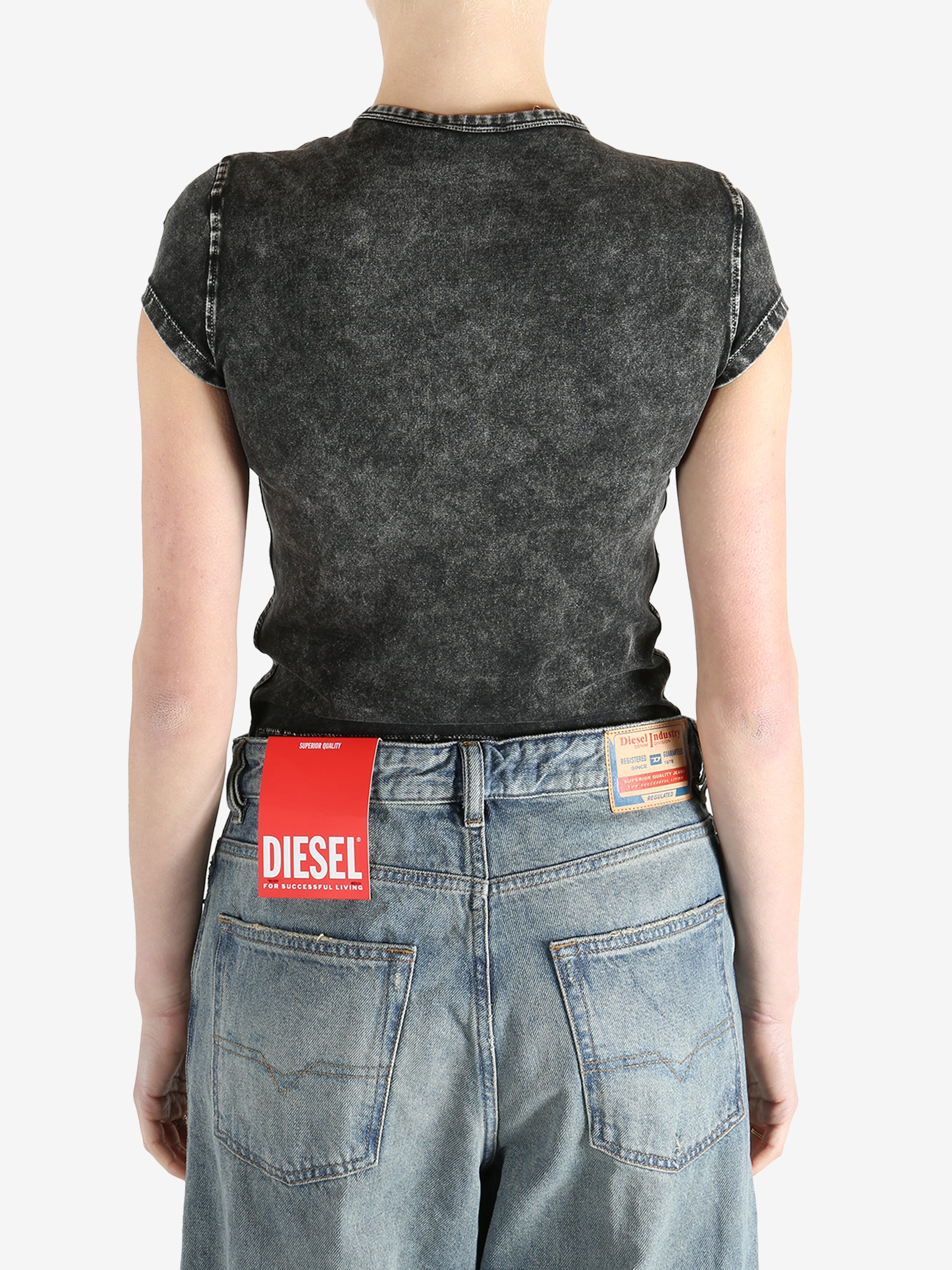 Black top worn by a person, showing the fit