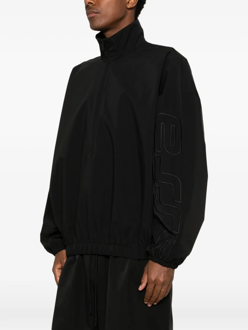 Black coats worn by a person, showing the coats fit