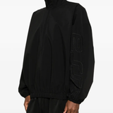Black coats worn by a person, showing the coats fit