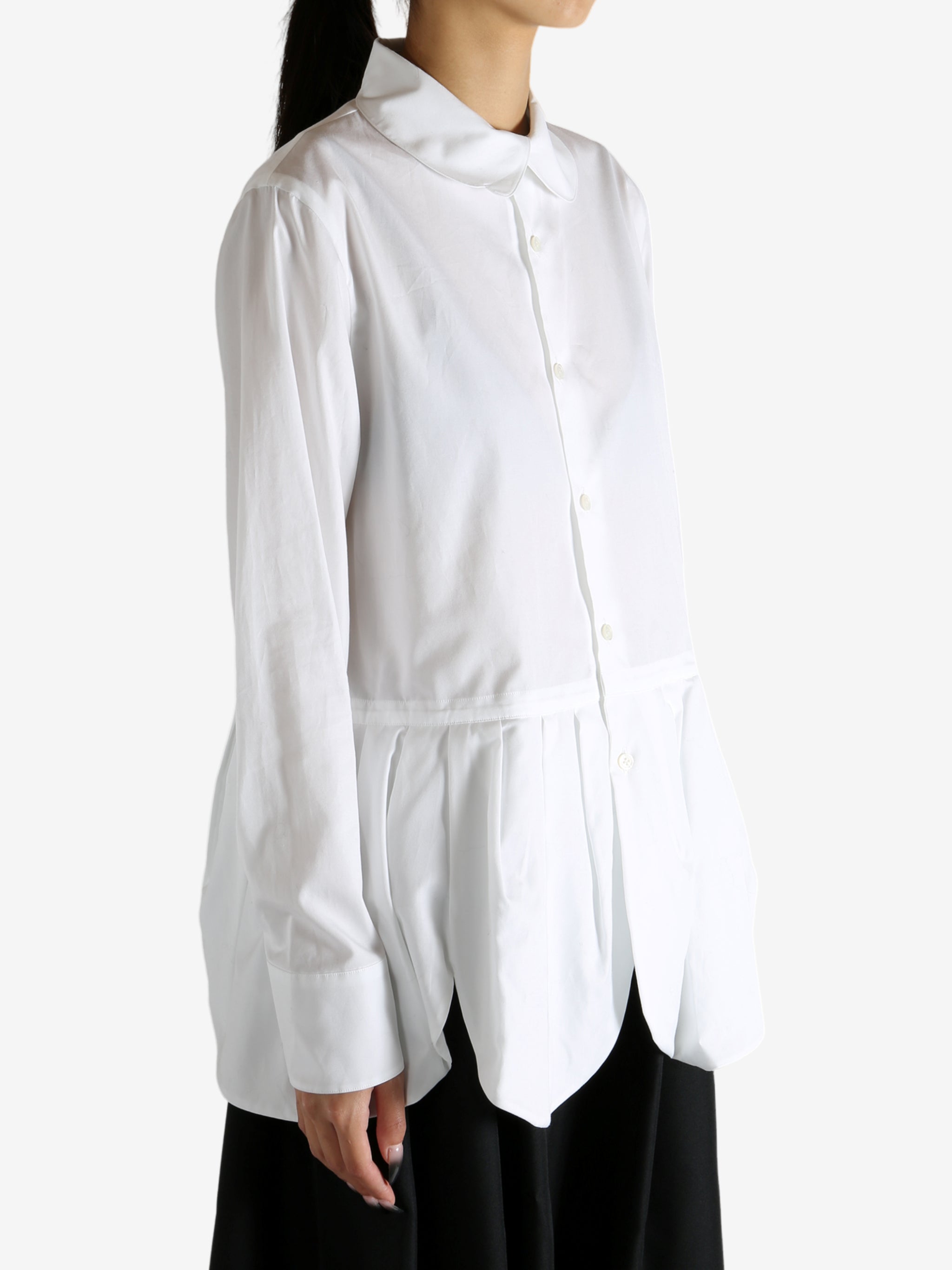 White shirt worn by a person, showing the shirt's fit