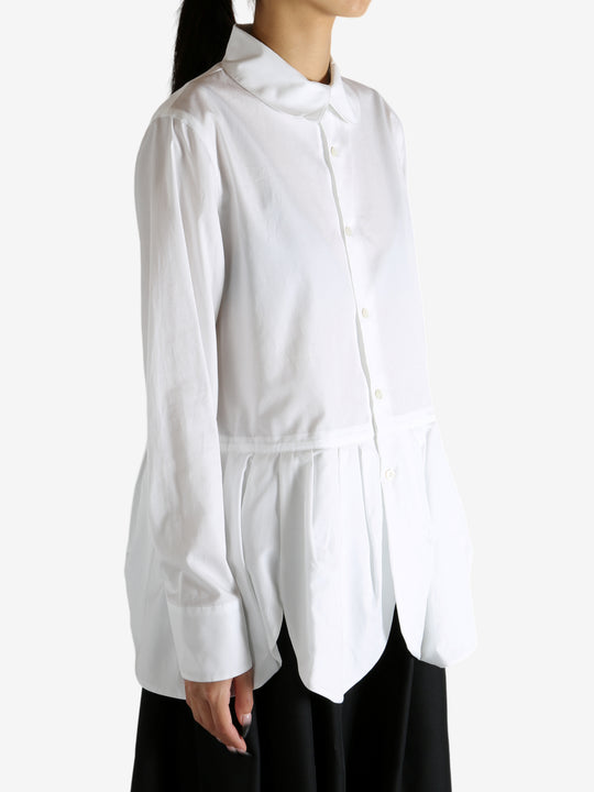 White shirt worn by a person, showing the shirt's fit