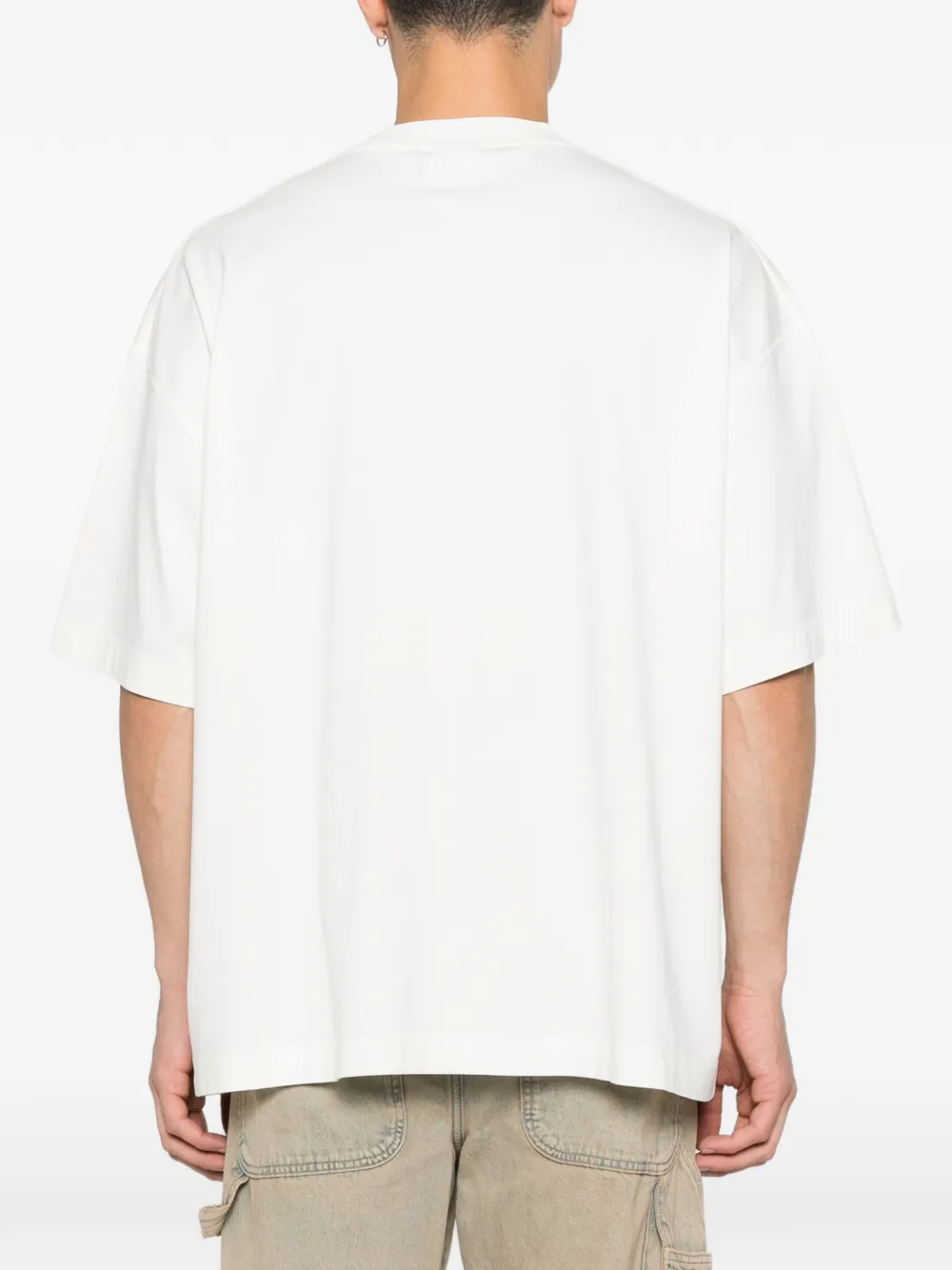 tan t-shirt worn by a person, showing the t-shirt fit